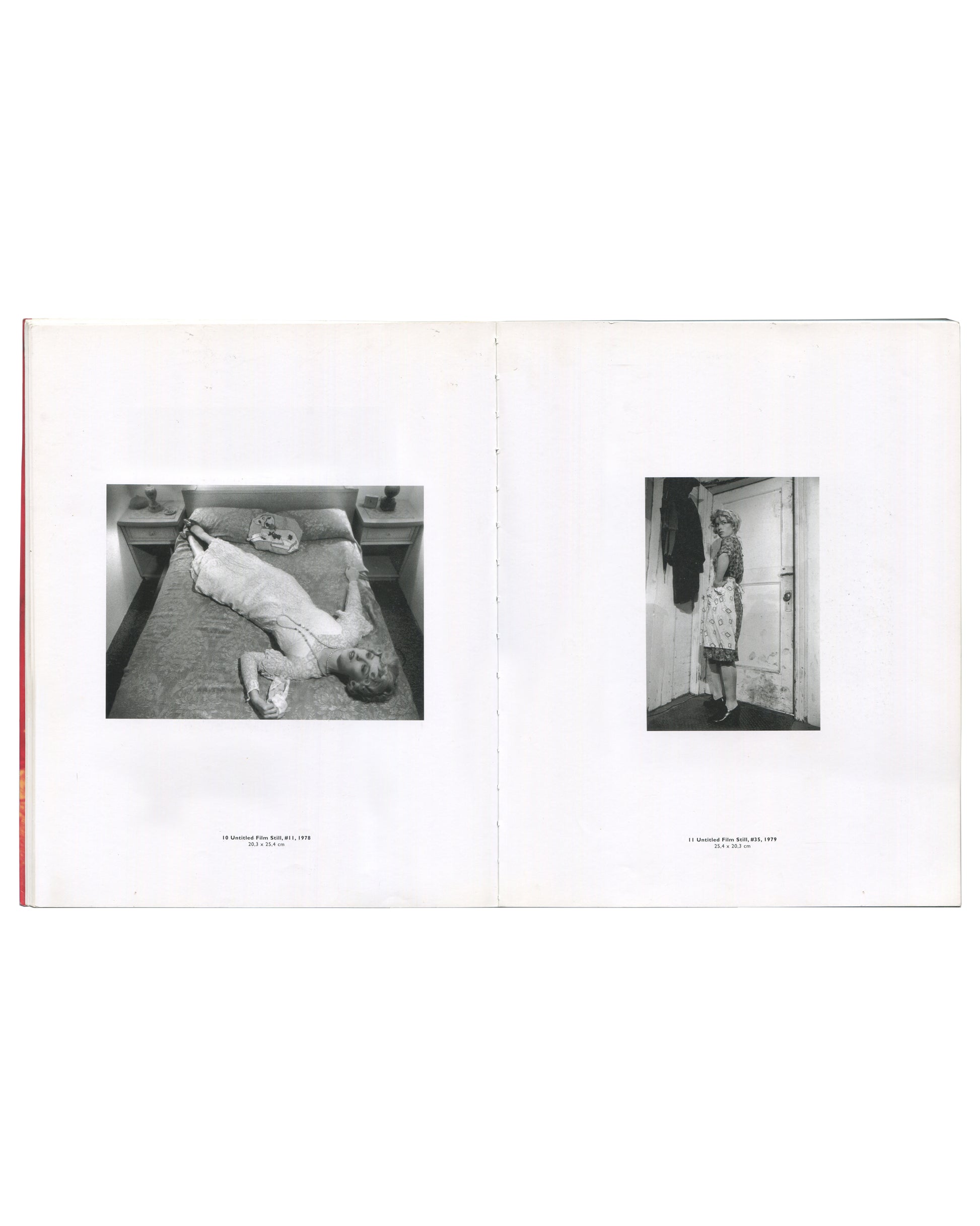 Cindy Sherman, Photographic Work 1975–1995, 1995, interior spread: b&w Untitled Film Stills #11 and #35, 1978–79 — woman on bed, mask on pillow; woman at door in apron, handbag; captions below
