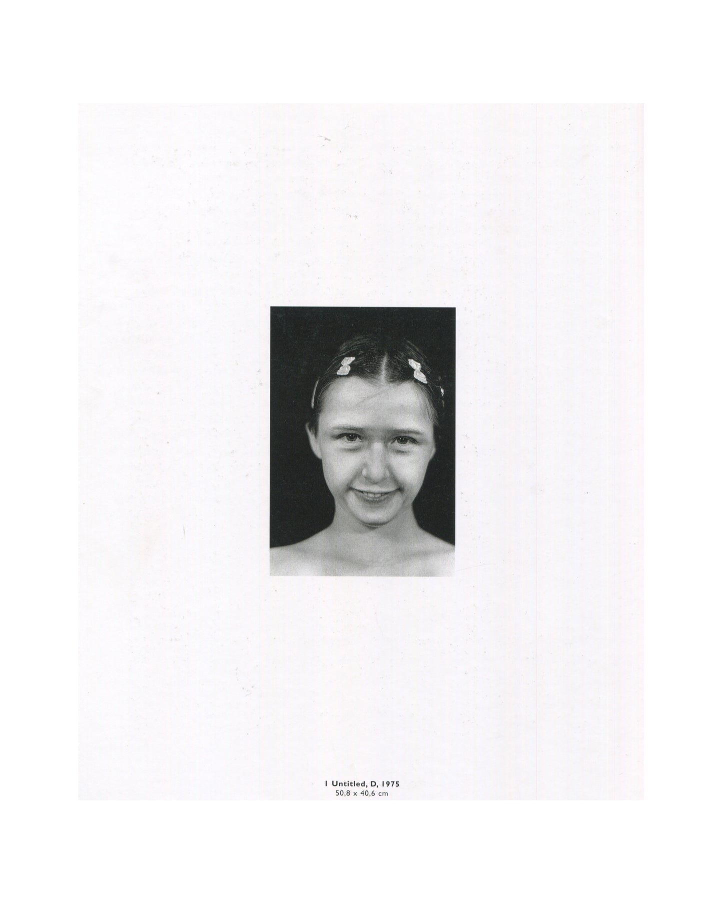 Cindy Sherman, Photographic Work 1975–1995, 1995, interior: b&w Untitled D, 1975 — close-up of young Sherman smiling, hair clips, dark ground; caption: 1 Untitled, D, 1975, 50.8 × 40.6 cm
