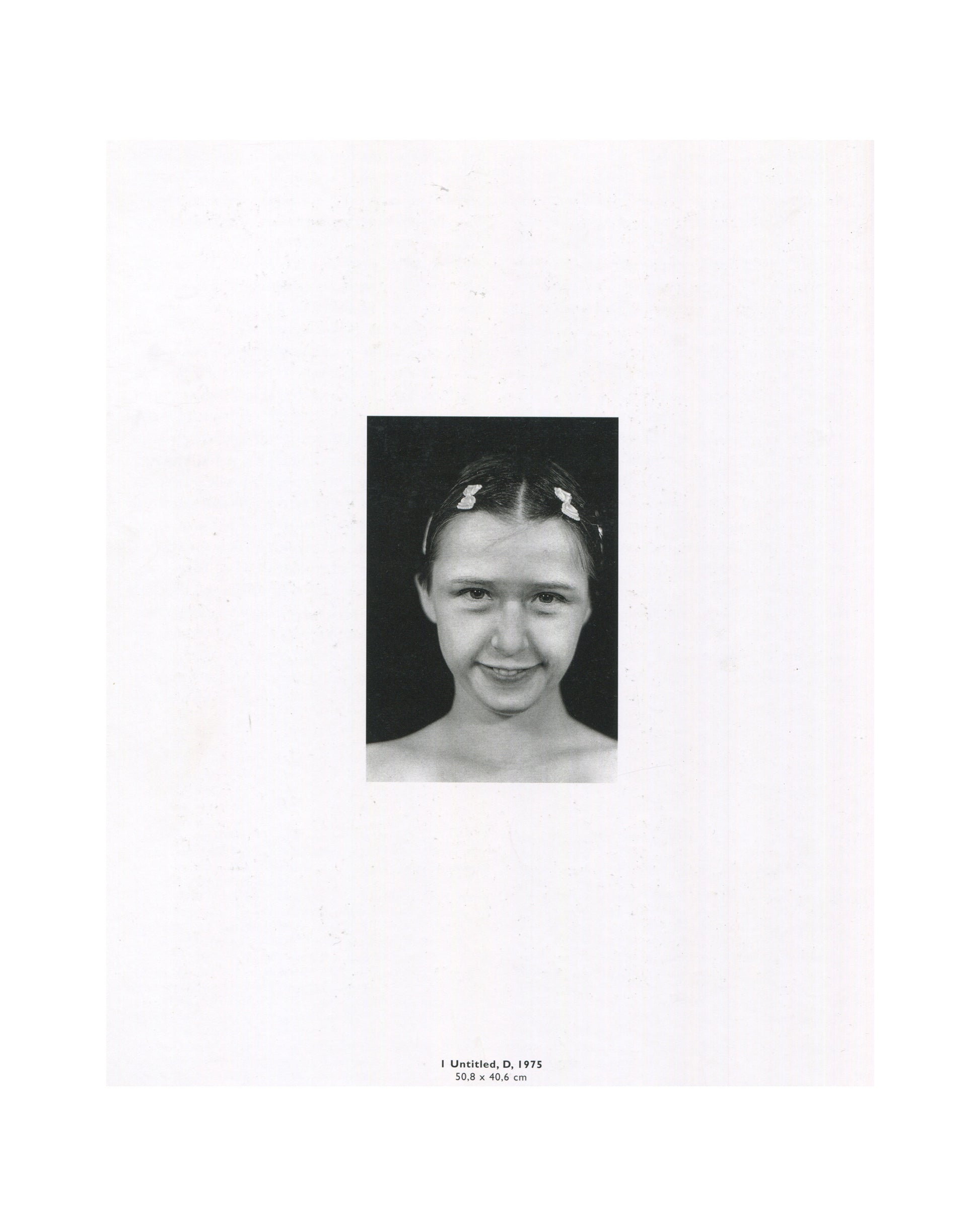 Cindy Sherman, Photographic Work 1975–1995, 1995, interior: b&w Untitled D, 1975 — close-up of young Sherman smiling, hair clips, dark ground; caption: 1 Untitled, D, 1975, 50.8 × 40.6 cm
