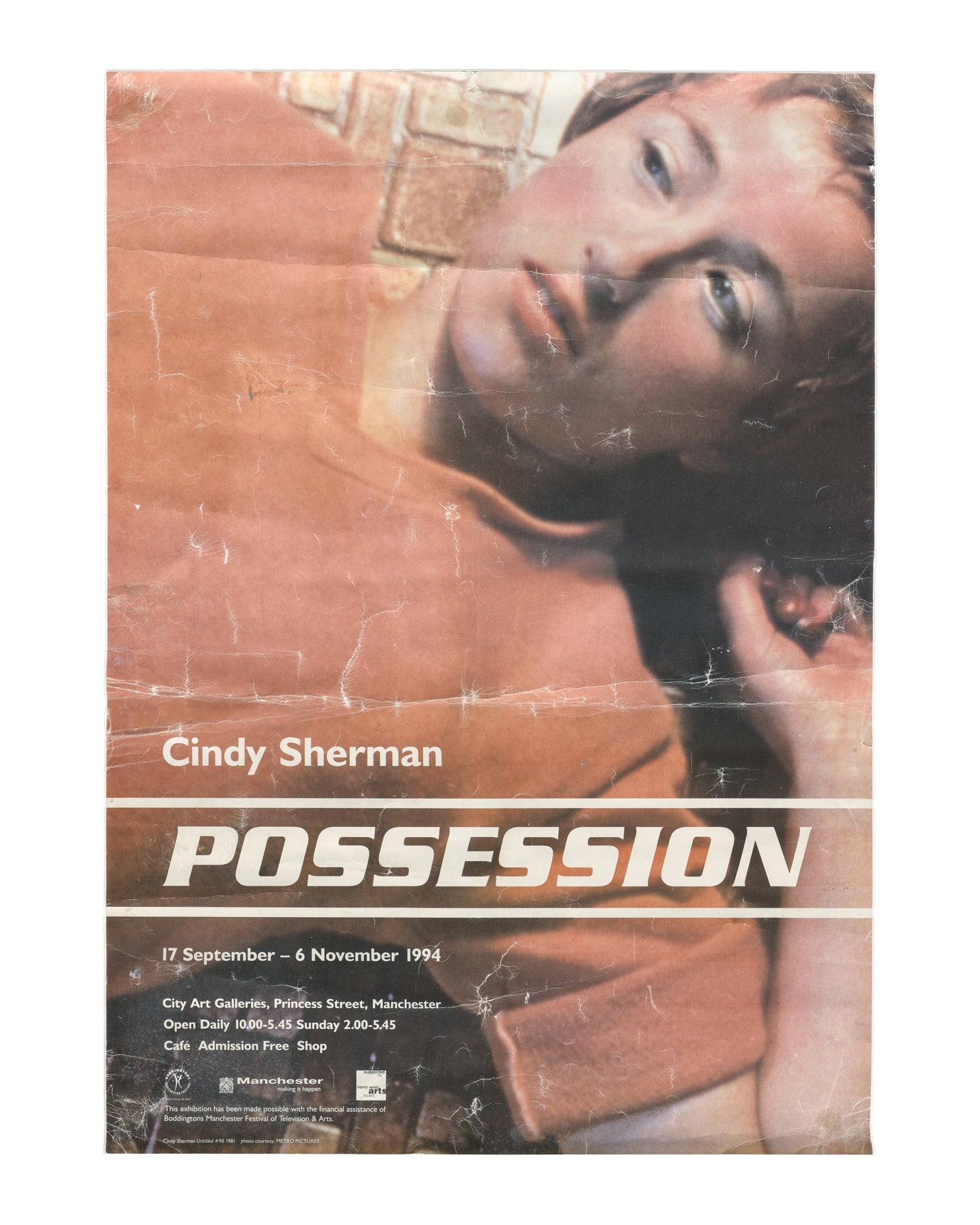 Original 1994 Cindy Sherman Possession exhibition poster, City Art Galleries, Princess Street, Manchester, 17 September – 6 November 1994. Offset lithograph, approx. 43 × 60 cm. Reproduces Untitled #96, 1981, from the Centerfolds series: figure reclining, face turned upward, warm terracotta tones. Good vintage condition with visible creasing, fold marks, and surface wear throughout.