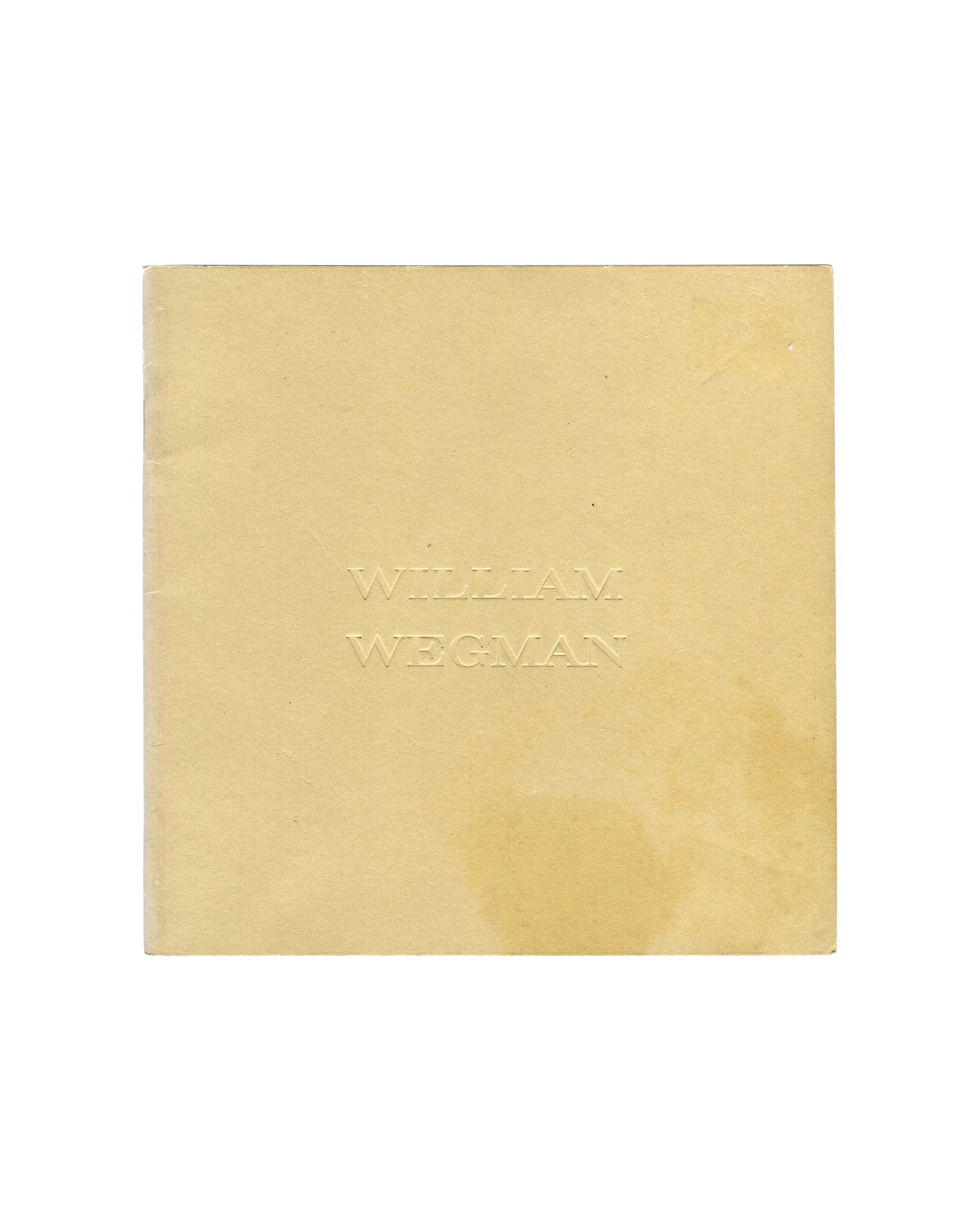 Softcover catalogue, William Wegman, New Paintings, Polaroids and Drawings / Early Black and White Photographs, Holly Solomon Gallery & Pace/MacGill Gallery, New York, 1991. 15 × 15 cm, approx. 23 pages, stapled binding. Tan paper wrappers; artist name 'WILLIAM WEGMAN' blind-debossed at centre — text visible through pressure only, no ink. Light toning and handling marks consistent with good vintage condition.

