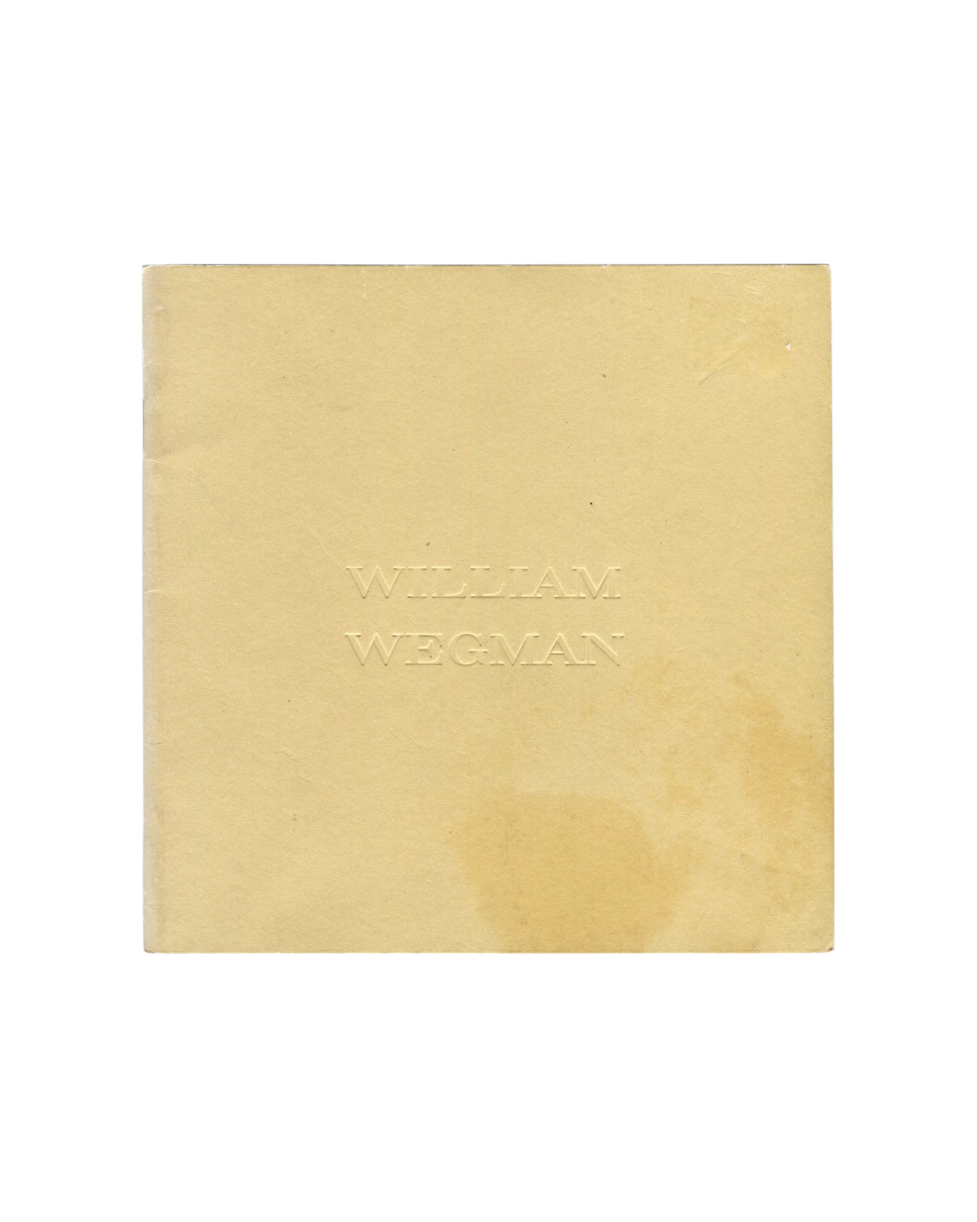 Softcover catalogue, William Wegman, New Paintings, Polaroids and Drawings / Early Black and White Photographs, Holly Solomon Gallery & Pace/MacGill Gallery, New York, 1991. 15 × 15 cm, approx. 23 pages, stapled binding. Tan paper wrappers; artist name 'WILLIAM WEGMAN' blind-debossed at centre — text visible through pressure only, no ink. Light toning and handling marks consistent with good vintage condition.

