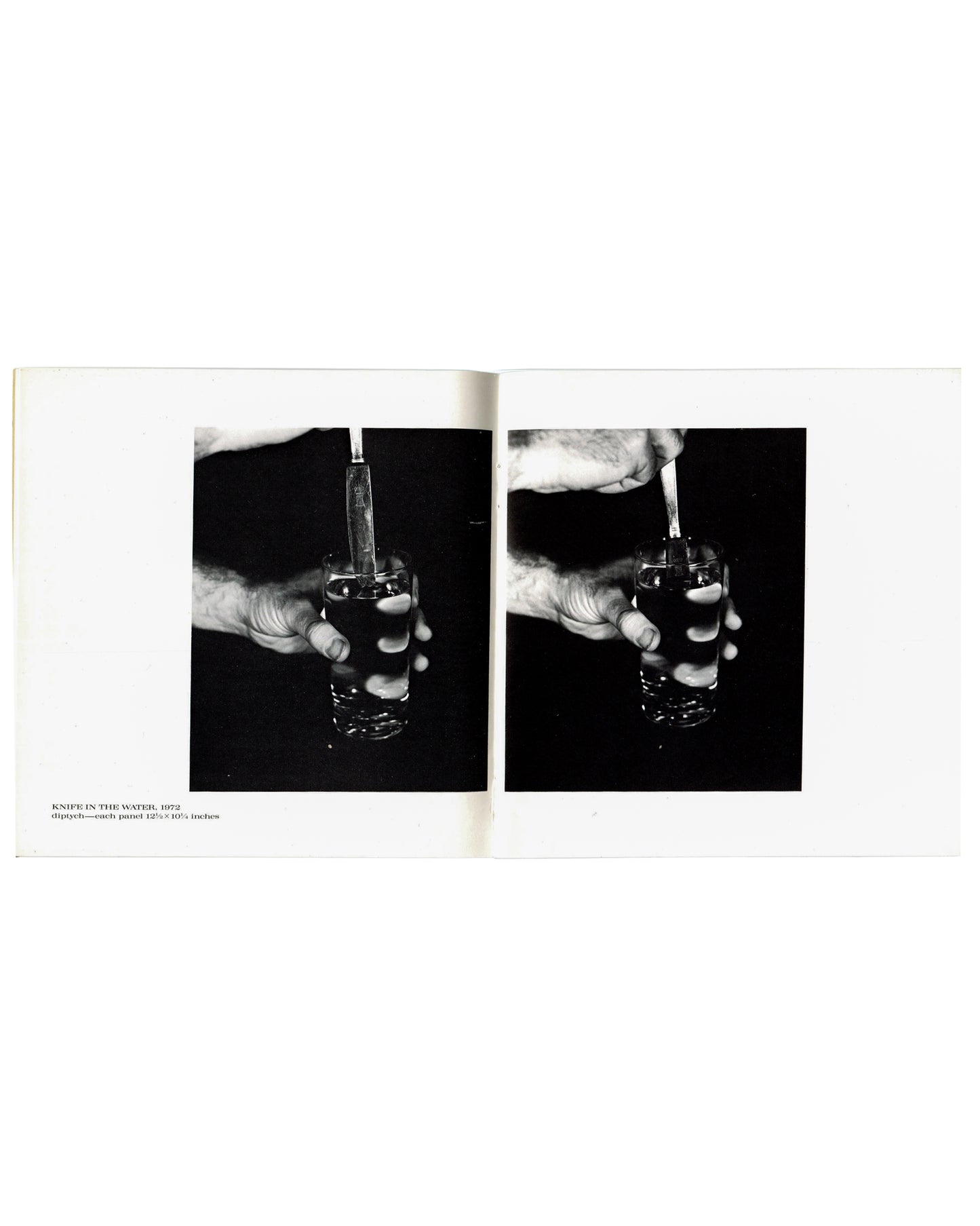 Interior spread, William Wegman, New Paintings, Polaroids and Drawings, Holly Solomon Gallery & Pace/MacGill Gallery, New York, 1991. Caption lower left: 'KNIFE IN THE WATER, 1972 / diptych — each panel 13⅝ × 10½ Inches'. Two black-and-white photographs side by side — close-up of hand gripping a glass of water with a knife inserted; dark studio background; slight variation between panels.
