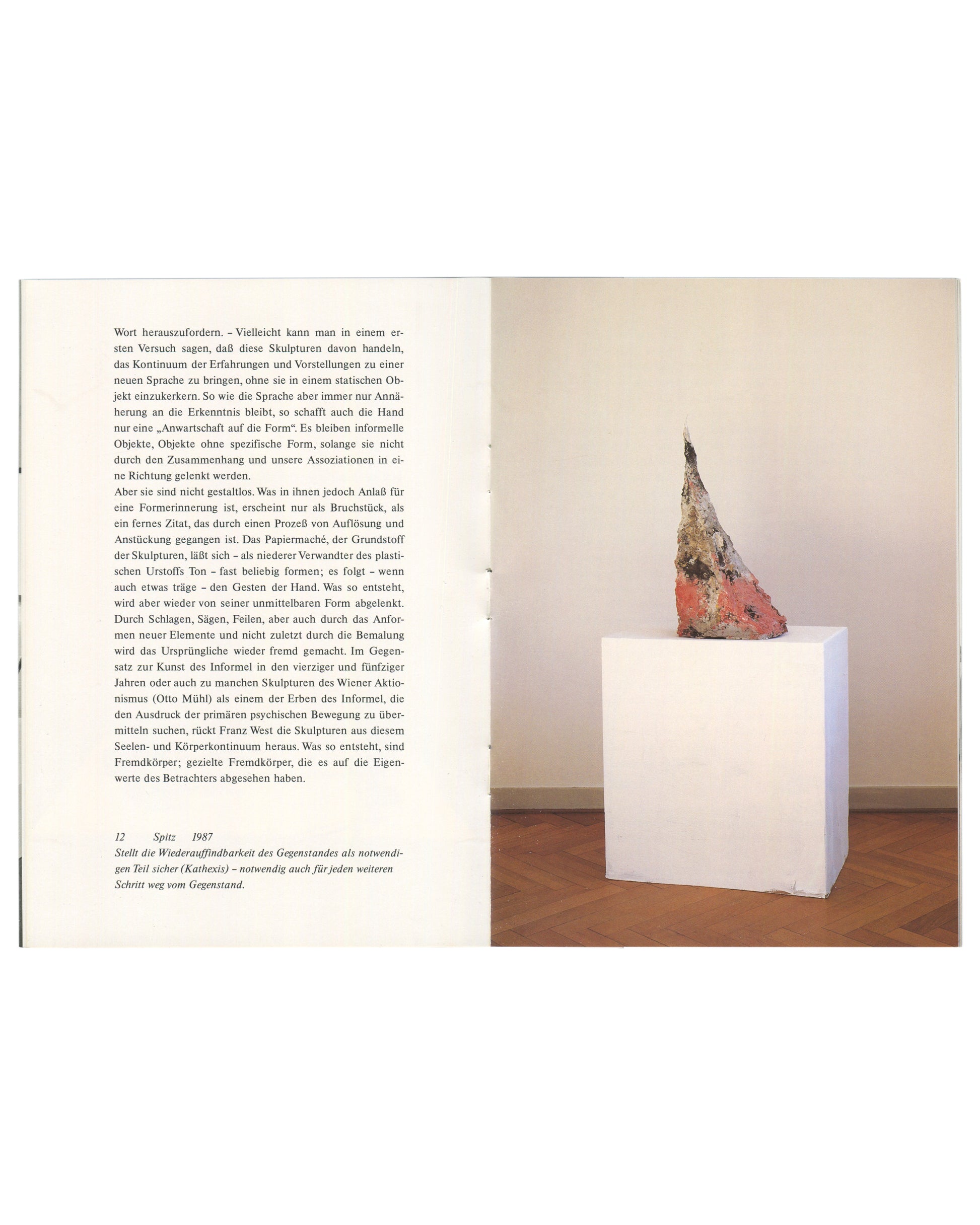 Interior spread, Franz West, Museum Haus Lange, Heft 1, Krefelder Kunstmuseen, Krefeld, 1989. Left page: continuation of Julian Heynen essay 'Fremdkörper und Eigenwerte' in small serif type, two columns; caption lower left '12  Spitz  1987' with italic caption text in German. Right page: colour photograph of Franz West, Spitz, 1987 — tall irregular conical papier-mâché sculpture, surface painted in pale pink, grey, and rust with rough brushwork and texture; placed on a white cubic plinth against a warm cre
