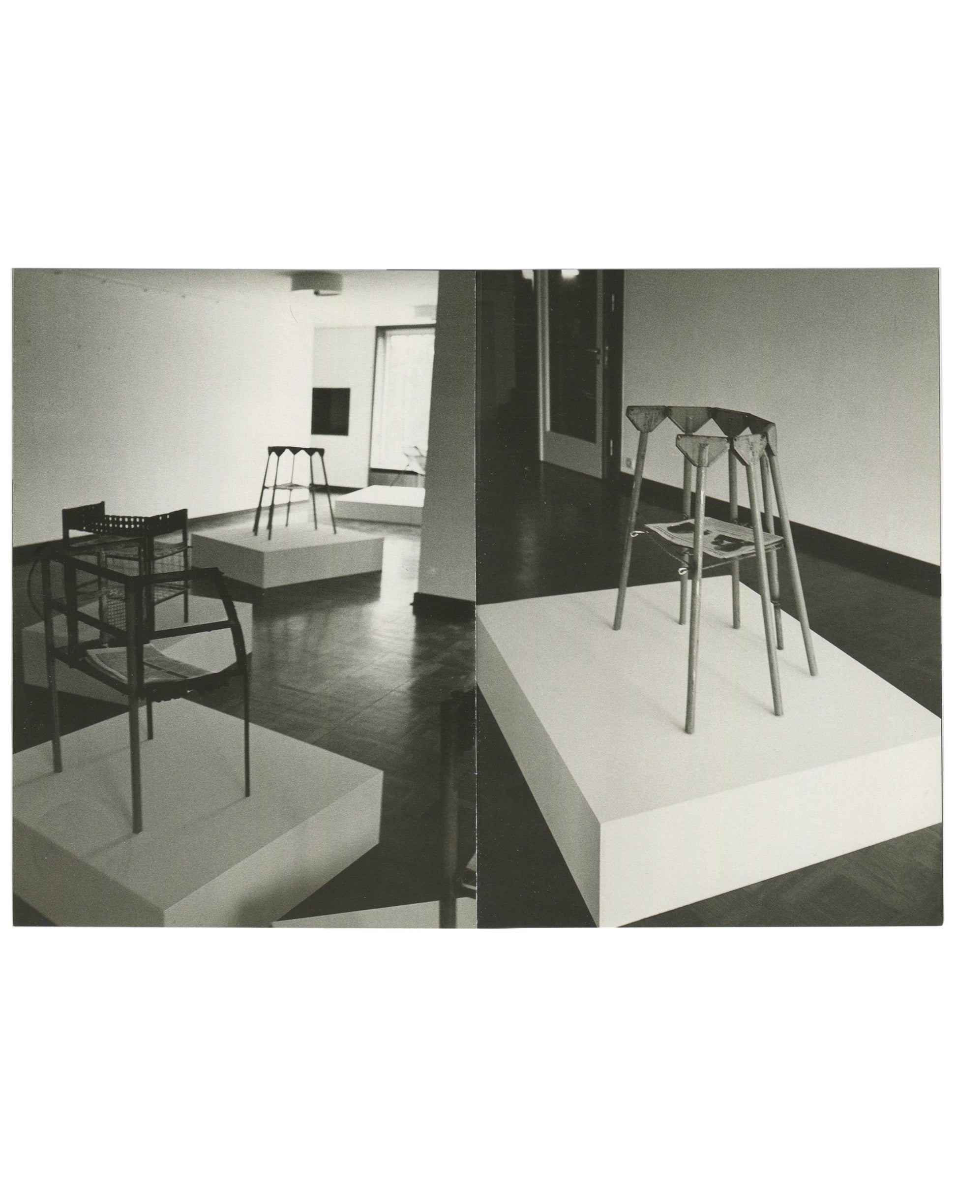 Interior spread, Franz West, Museum Haus Lange, Heft 2, Krefelder Kunstmuseen, Krefeld, 1989. Two black-and-white installation photographs by Günther Förg. Left: gallery room — wire-frame chair and perforated-seat chair on white plinths, tall multi-legged stool form in background, dark reflective floor. Right: close-up of tall multi-legged sculptural stool with folded/draped upper element on white plinth; publications visible on plinth surface.