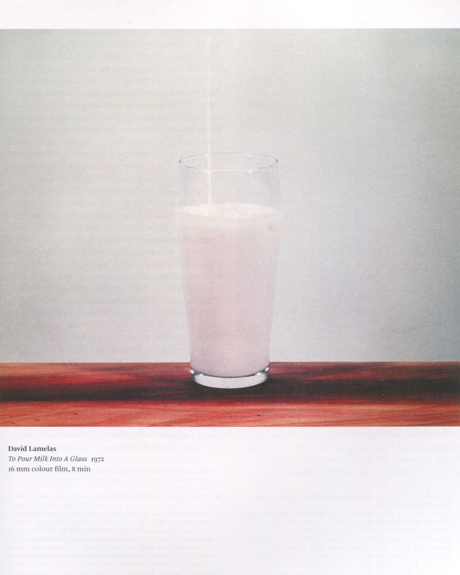 Andrew Wilson, ed., Conceptual Art in Britain 1964–1979, 2016, interior: colour — David Lamelas, To Pour Milk Into A Glass, 1972, glass of milk on wooden shelf, grey ground; caption below

