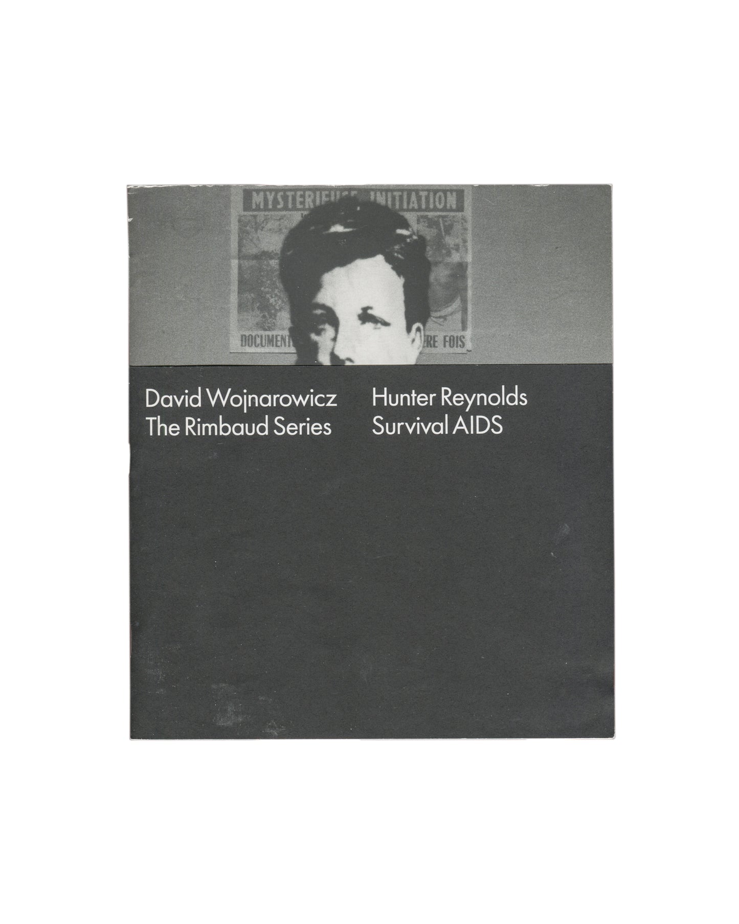 David Wojnarowicz / Hunter Reynolds, The Rimbaud Series / Survival AIDS, P.P.O.W Gallery, New York, 2012. Artist publication / exhibition catalogue, softcover, approx. 20 × 23 cm, 16 pages. Design by Project Projects. Two-panel cover: upper half, grey band with cropped black-and-white photograph — masked figure (Arthur Rimbaud mask) against a wall bearing a partially visible poster reading 'MYSTERIOUS INITIATION' and 'DOCUMENT… RE FOIS'; lower half, dark charcoal ground with white sans-serif text in two col