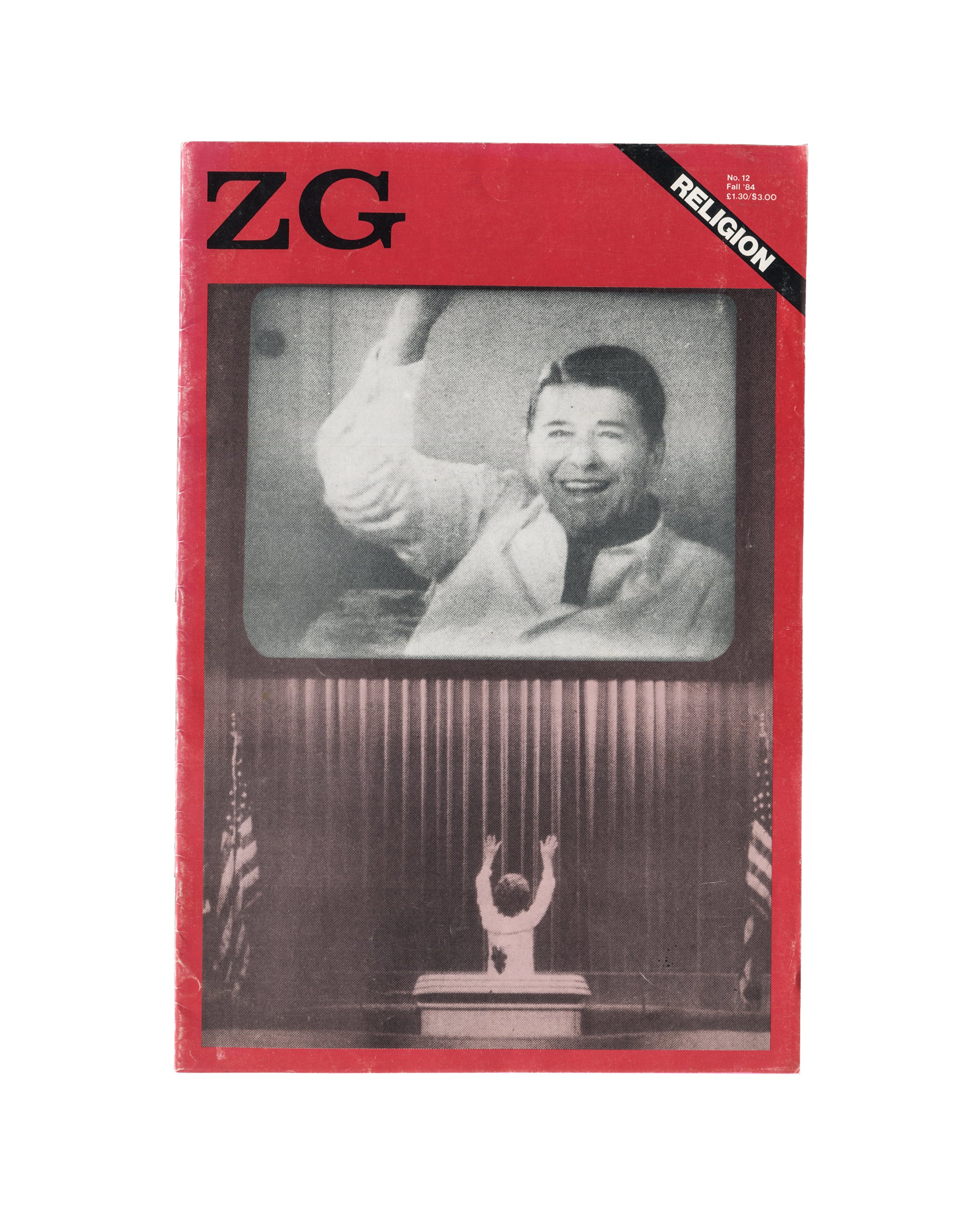 Magazine cover, ZG Magazine No. 12: Religion, edited by Rosetta Brooks, New York, Fall 1984. Offset-printed, staple-bound periodical, 41.9 × 27.9 cm. Red ground. Upper left: bold black 'ZG' logotype. Upper right: black diagonal band — white bold sans-serif 'RELIGION'. Centre: black-and-white photograph of a television set showing a smiling male figure in white jacket raising one arm — televangelist or political figure; below the TV screen: small silhouetted figure with arms raised before a podium, flanked b