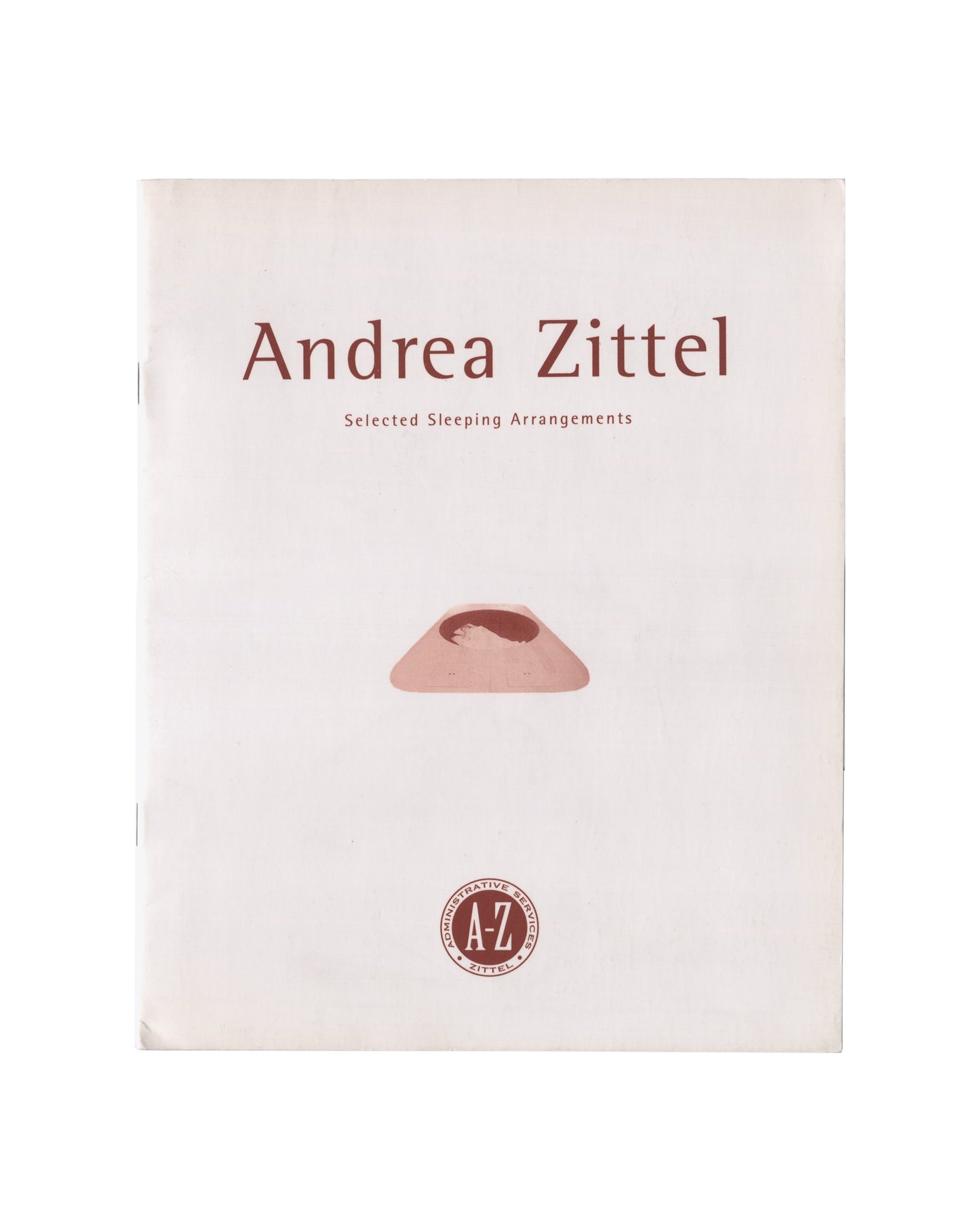 Cover of Andrea Zittel, Selected Sleeping Arrangements: The A-Z Bed Book, 1995. A-Z Administrative Services / Transcript, University of Dundee. 21 × 26 cm, staple-bound softcover, 16 pp. Pale cream stock with reddish-brown typography. Title 'Andrea Zittel' in large serif type, subtitle 'Selected Sleeping Arrangements' in spaced capitals below. Centre: colour photograph of A-Z Sleeping Loft, 1994 — low rounded terracotta-coloured foam form on white ground. Lower centre: circular A-Z Administrative Services s