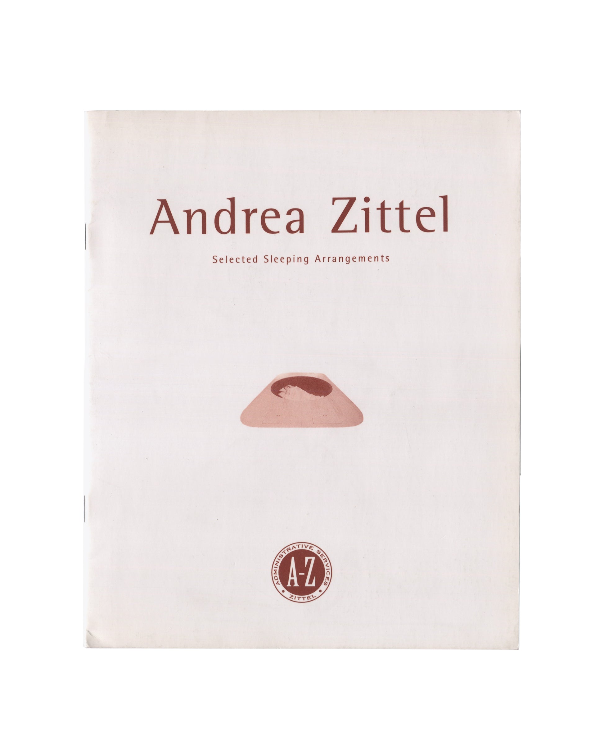 Cover of Andrea Zittel, Selected Sleeping Arrangements: The A-Z Bed Book, 1995. A-Z Administrative Services / Transcript, University of Dundee. 21 × 26 cm, staple-bound softcover, 16 pp. Pale cream stock with reddish-brown typography. Title 'Andrea Zittel' in large serif type, subtitle 'Selected Sleeping Arrangements' in spaced capitals below. Centre: colour photograph of A-Z Sleeping Loft, 1994 — low rounded terracotta-coloured foam form on white ground. Lower centre: circular A-Z Administrative Services s